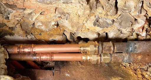 Résultat de l'intervention sanitaire à Brumath avec l'installation de nouveaux tubes en cuivre reliés par des raccords à sertir en laiton sur l'ancien réseau.