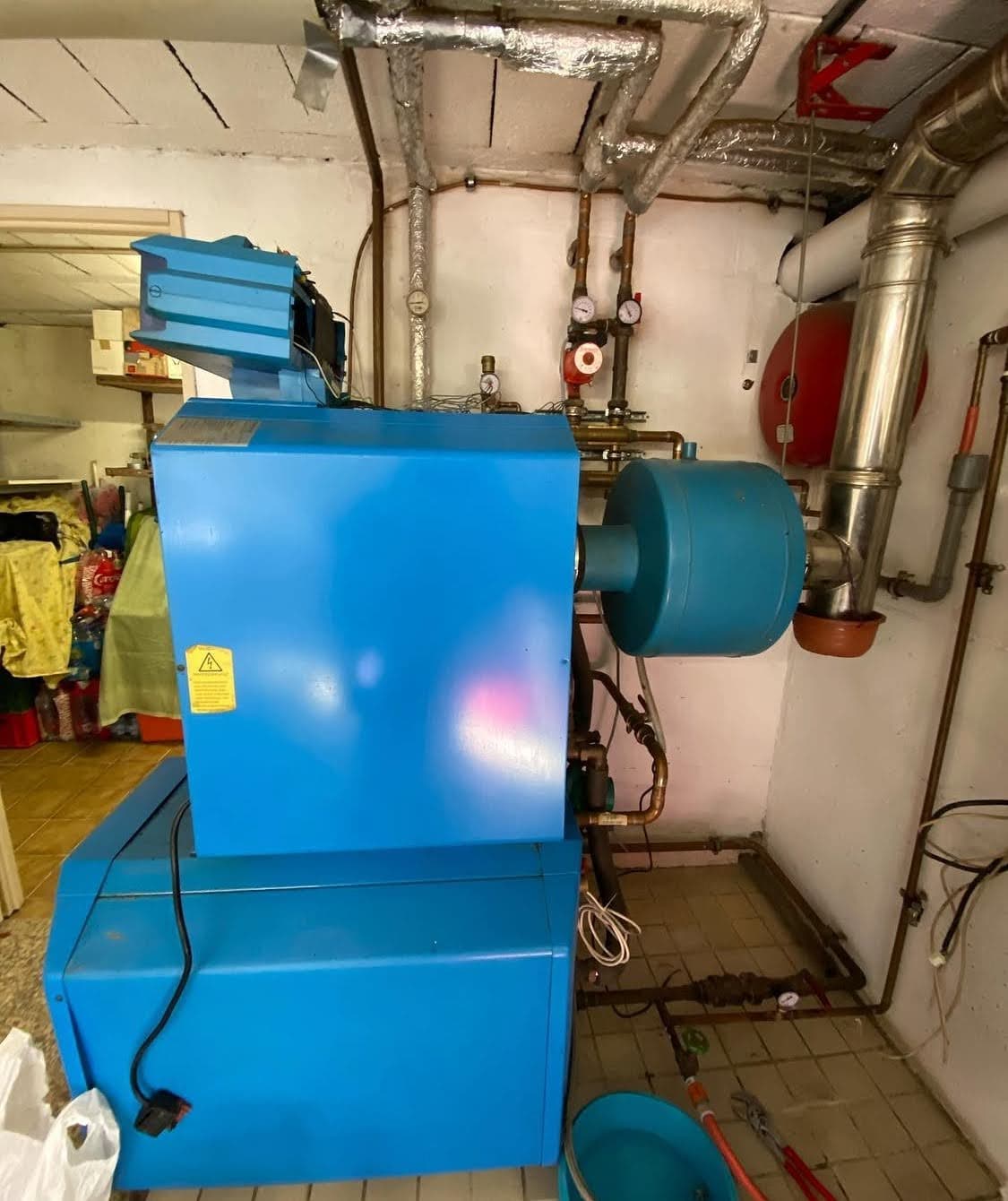 Ancienne chaudière fioul polluante, encombrante et énergivore, avant son démantèlement pour procéder à l'installation d'une nouvelle pompe à chaleur à Obernai.